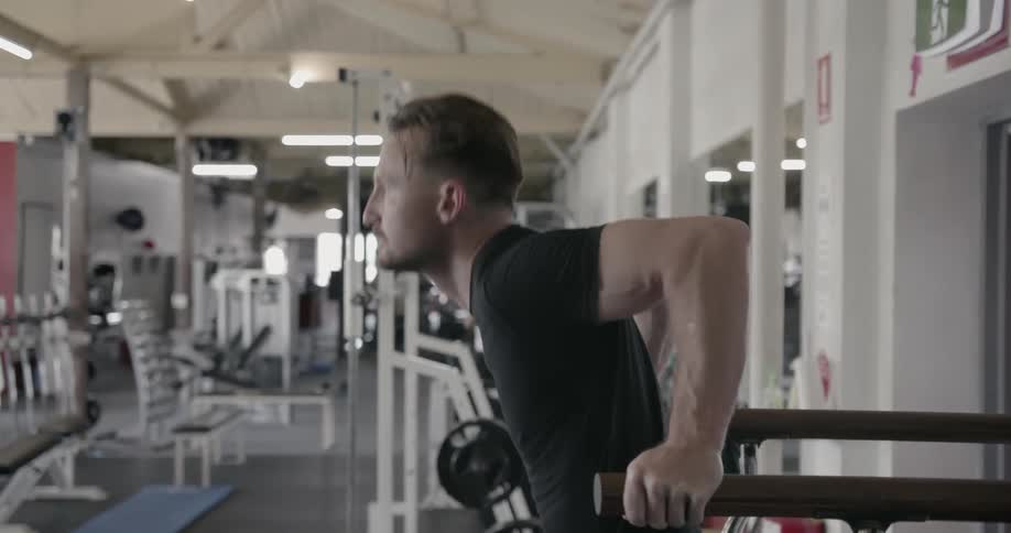 A man exercises on gym equipment