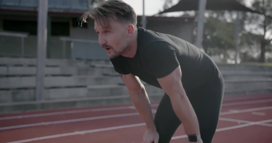 A man is leaning forward before running