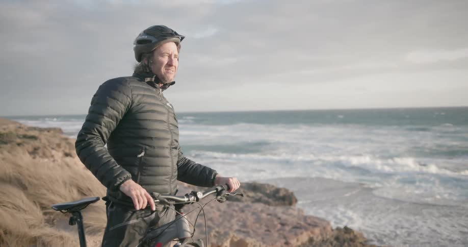 A man watches the ocean on a windy day