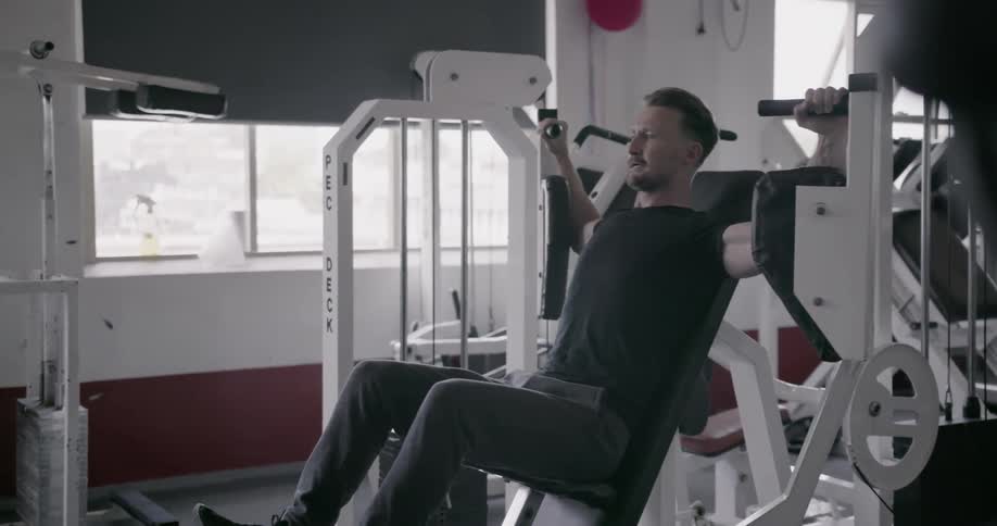 A man exercises on a weight machine