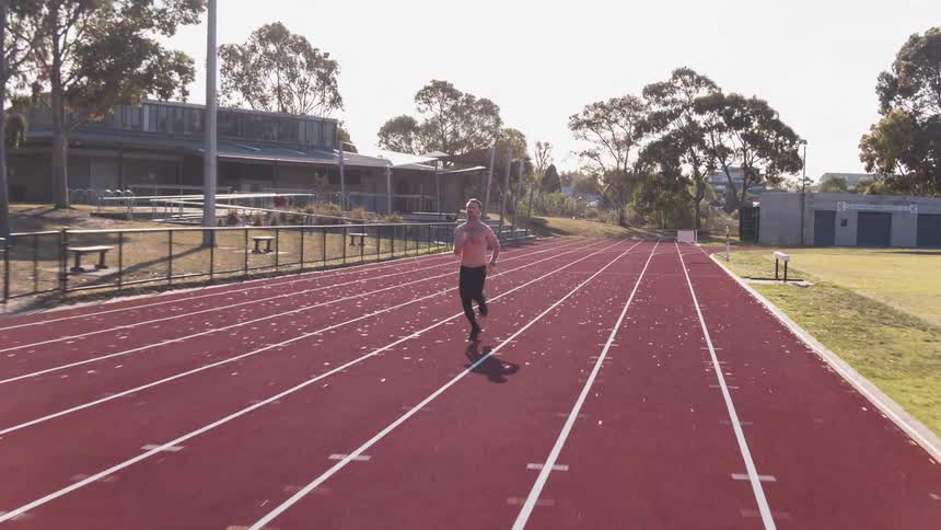 A man sprints on a running track