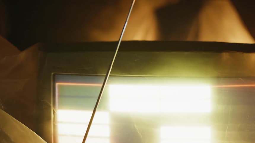 Lights flashing on an old monitor with smoke behind it