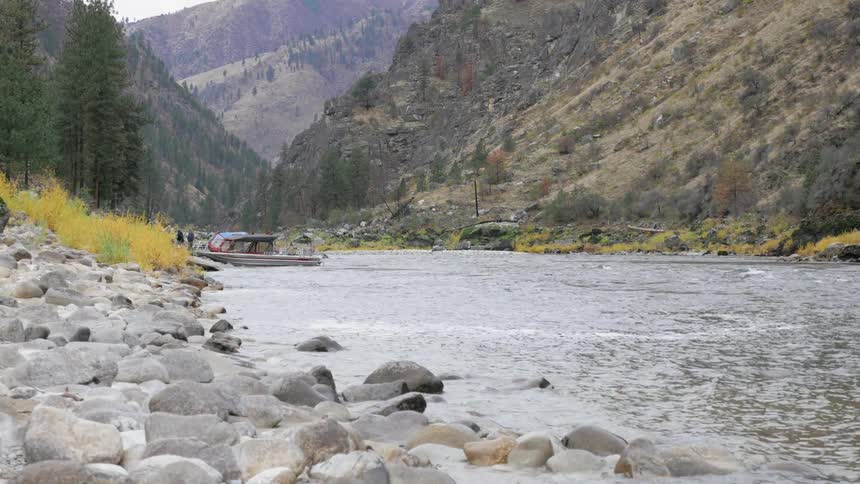 People stand by a boat in the stream