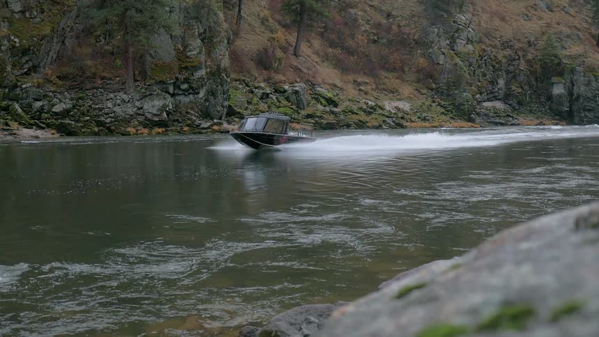 The boat moves fast in the stream water
