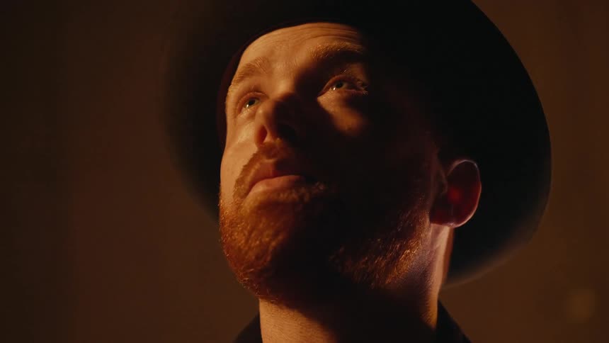 A man is looking up toward the ceiling and closing her eyes