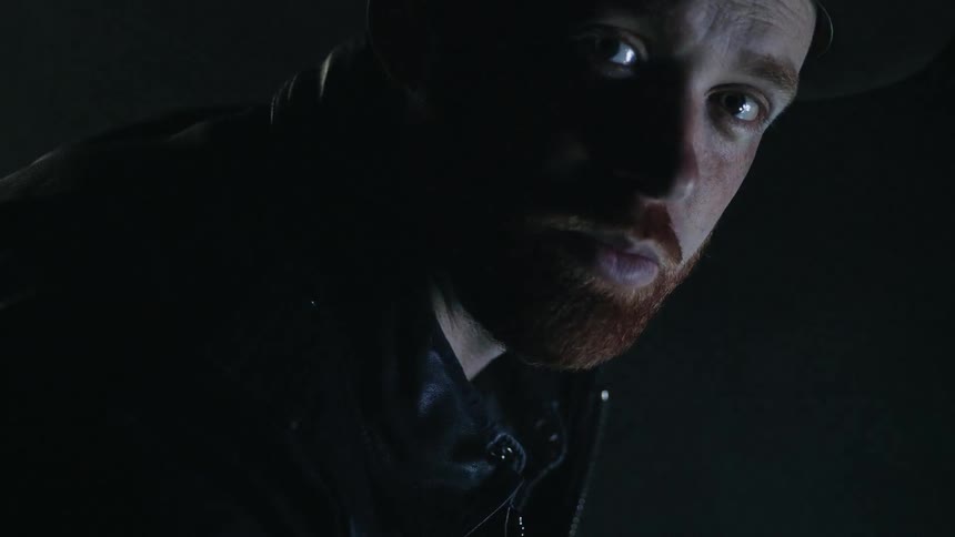 A man stands in the dark