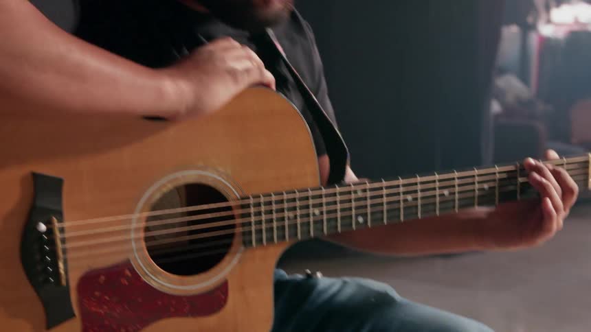 A child is having a guitar lesson