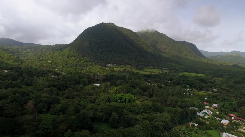 Clouds hang over green hills in the Panamanian rainforest
