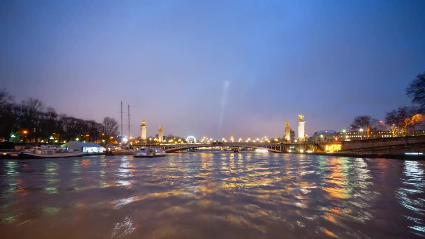 The lights on the bridge illuminate the water