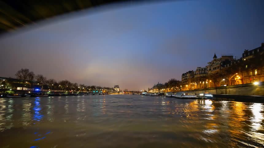 A boat travels fast in the canal water at sunset