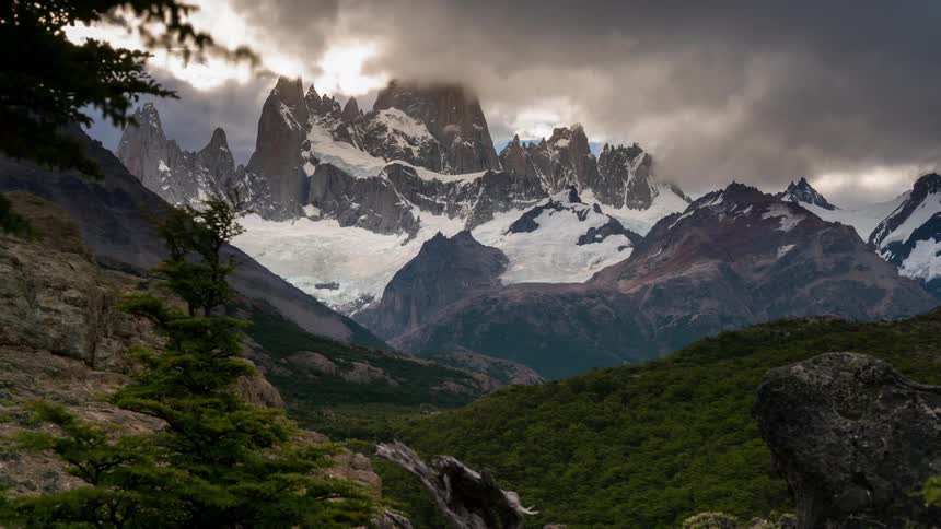 The clouds move slowly over the mountain top