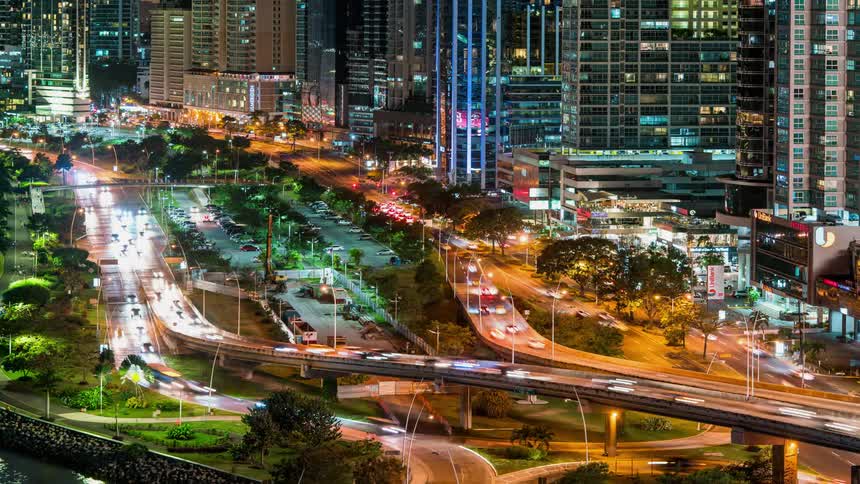 Cars driving on many highways in a city at night