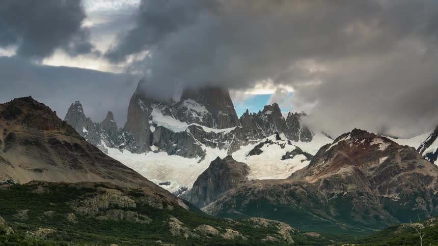 The clouds roll off the top of the mountain