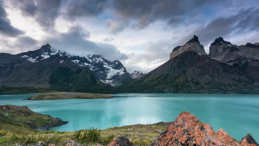 The water of the lake is blue near the mountains