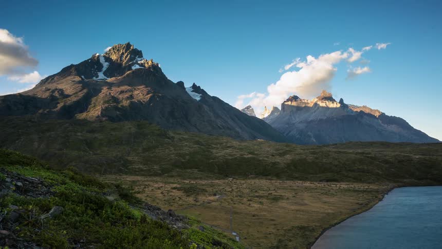 Clouds are drifting over mountain peaks through the day