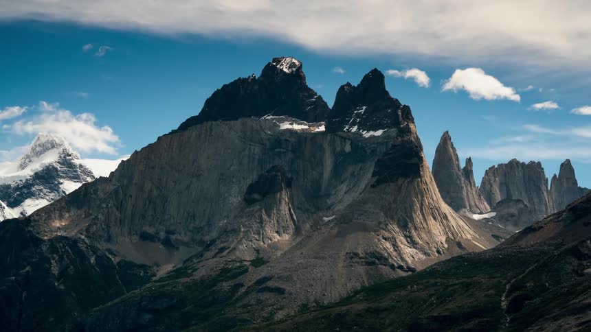 The mountain is tall with the clouds touching the top