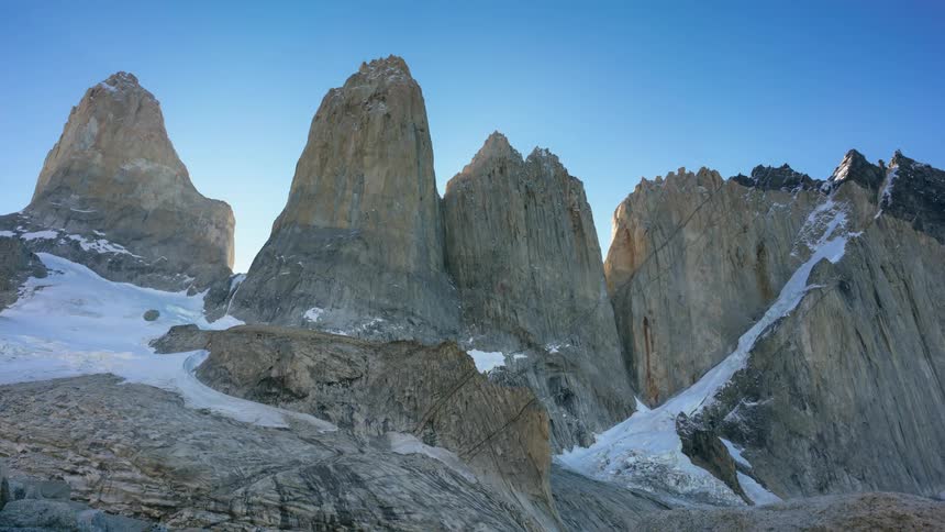 The sky is blue above the mountain rocks