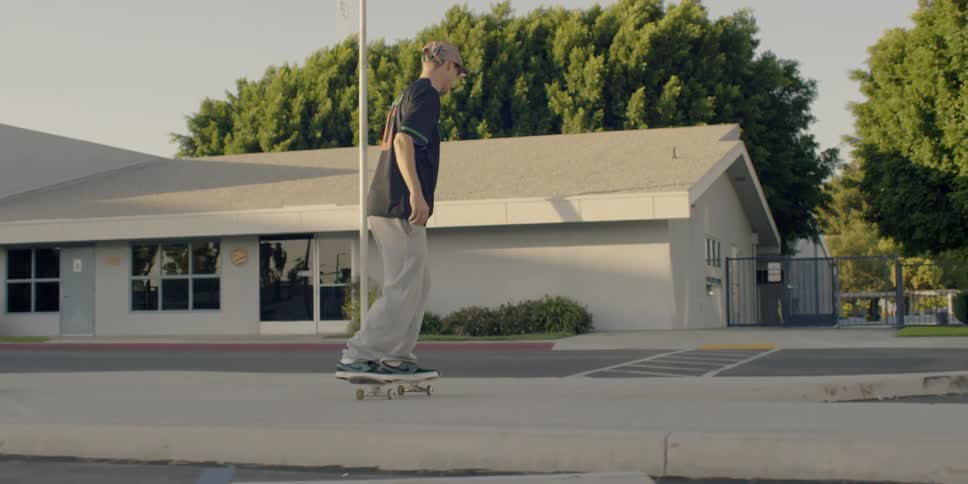 Men do jumps riding skateboards in the parking lot
