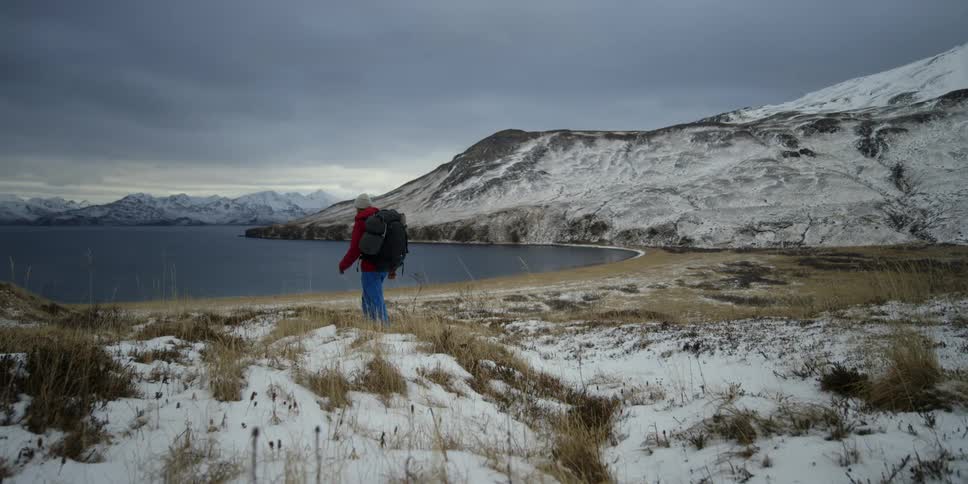 A man hikes towards the water