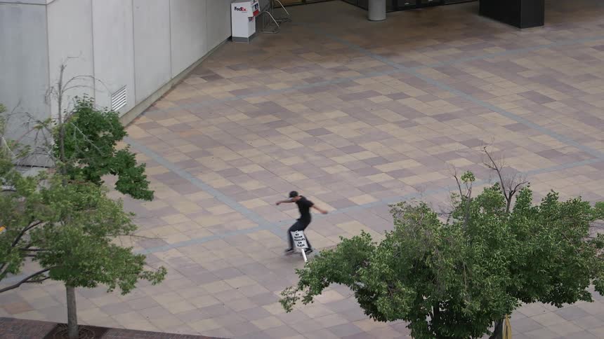 A man rolls by on a skateboard