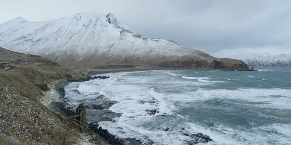 Waves crash onto the rocky winter shore