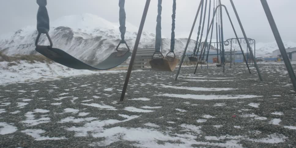 Swings sway on a snowy day