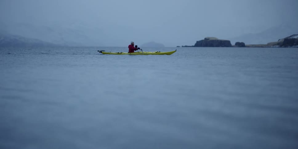 Person paddling in a yellow sea kayak