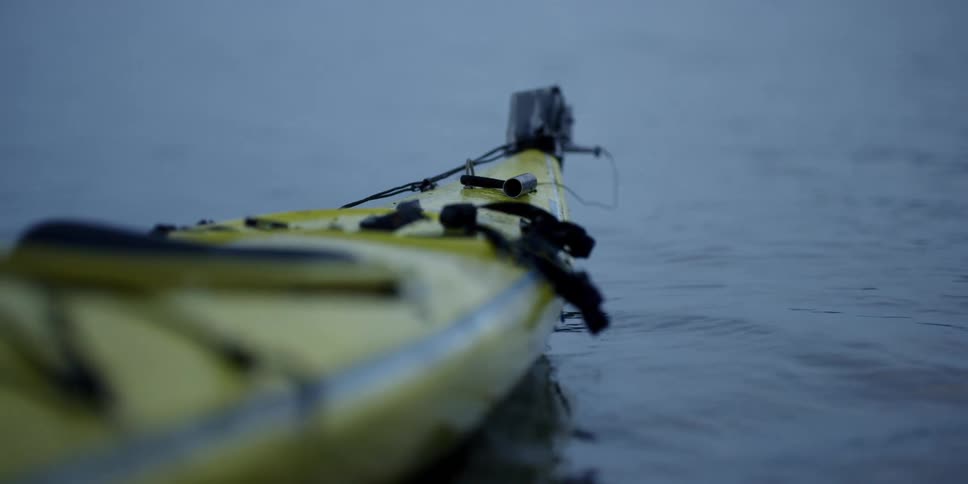 A yellow kayak floats in the water