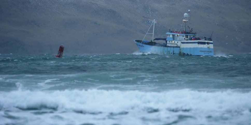 A boat travels on rough waters