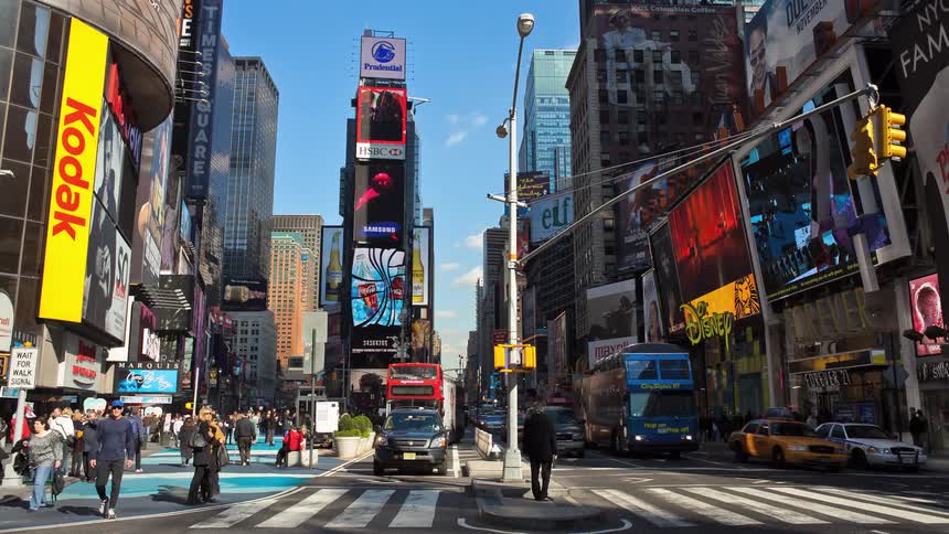Cars and pedestrians commute in a city