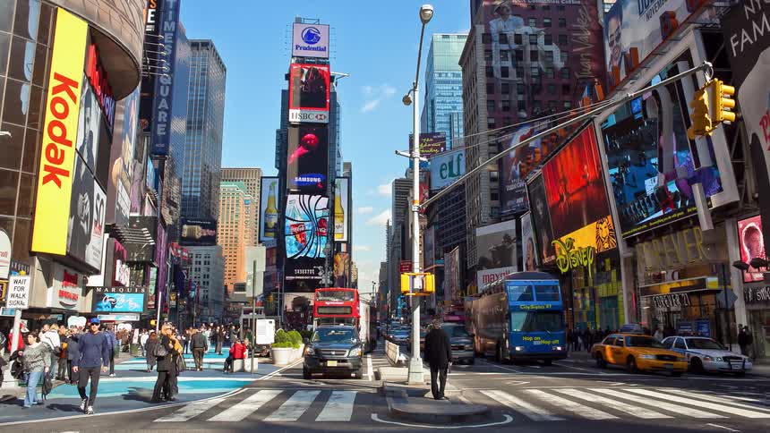 Vehicles and pedestrians navigate a busy city street