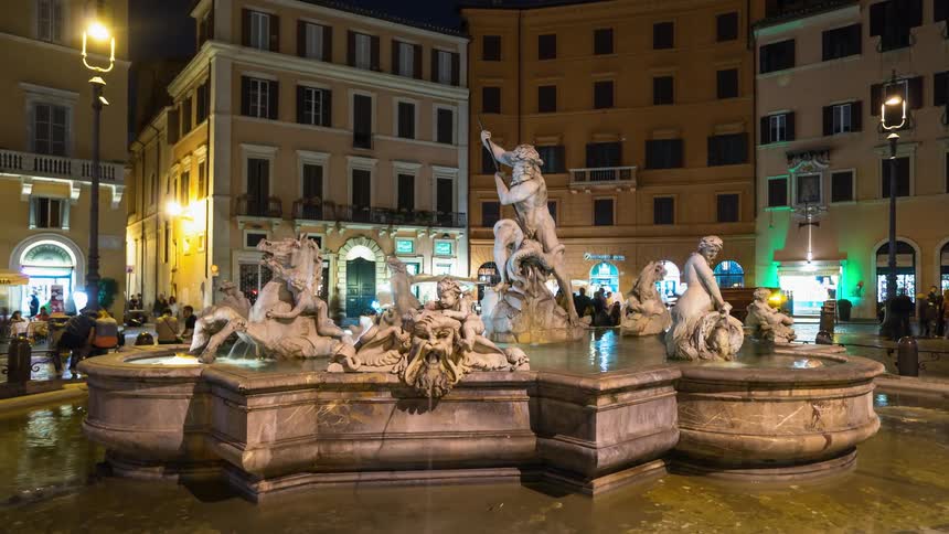 The people walk by the fountain in the city