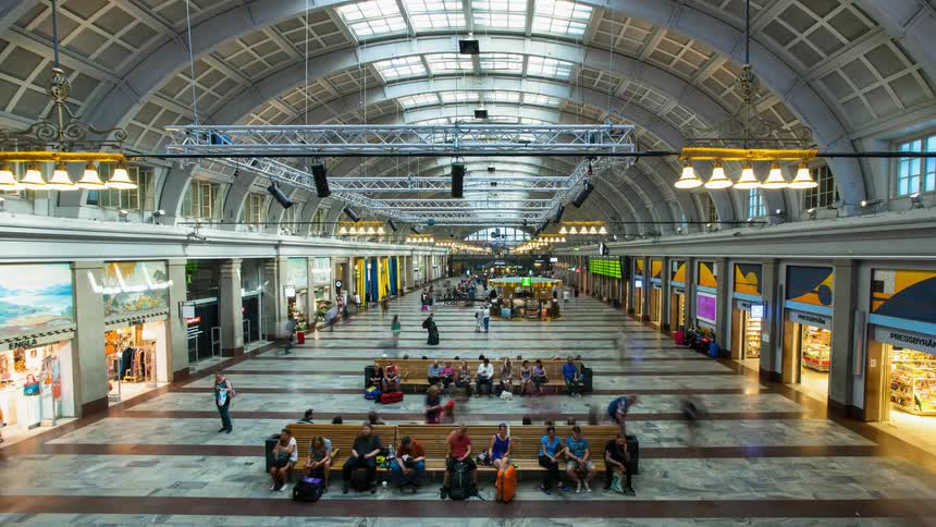 Travelers walk in a big train station