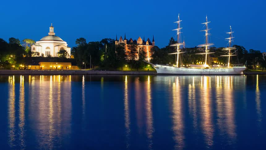 Water flows on the canal by the city at night