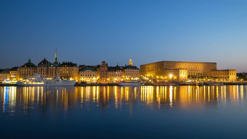 City lights illuminate on the shore of the canal