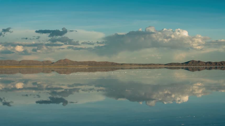 Clouds rolling over a still body of water