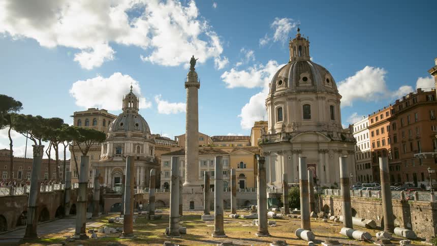 People walk through and observe monuments on a sunny day