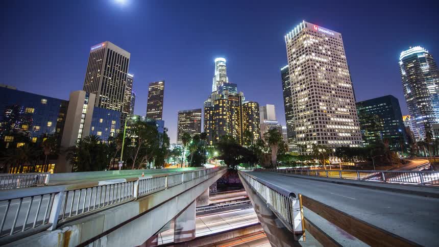 Vehicles commuted along a city highway overpass at night
