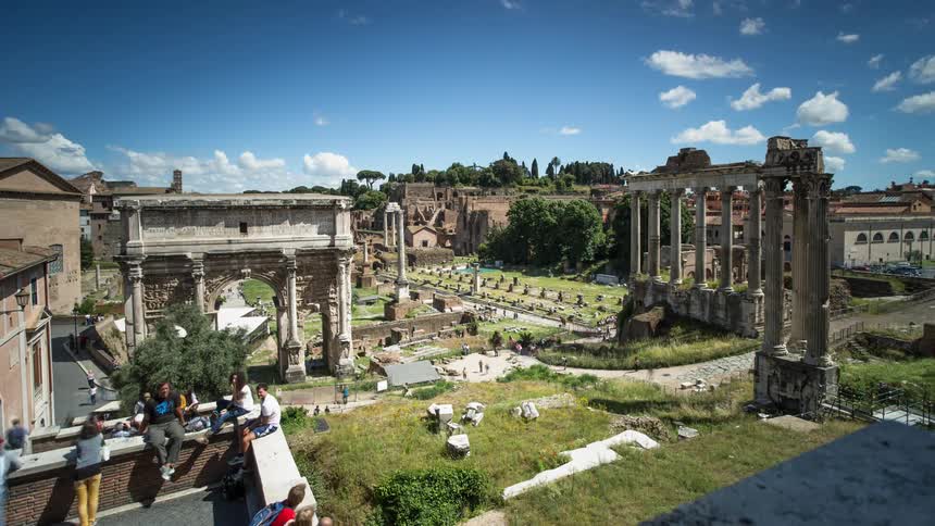 People walk through and observe monuments on a sunny day