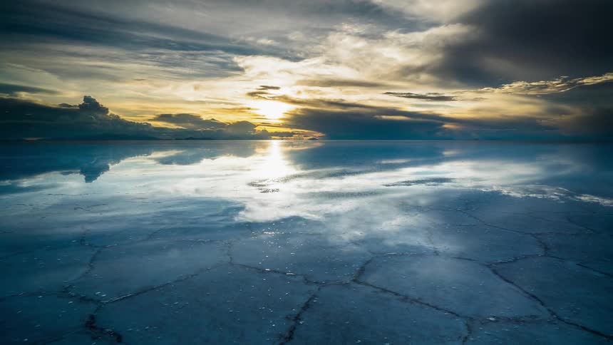 The sun rises above the water