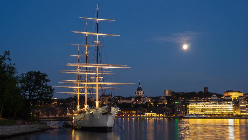 Close view of a boat floating on a city river at dusk