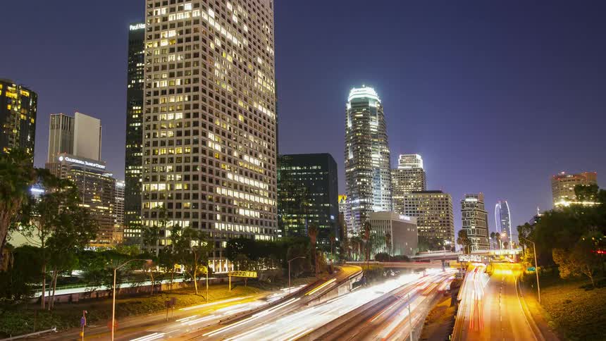 Vehicles travel on a city road at night