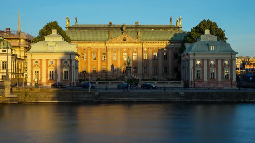 River water flows in front of a city building
