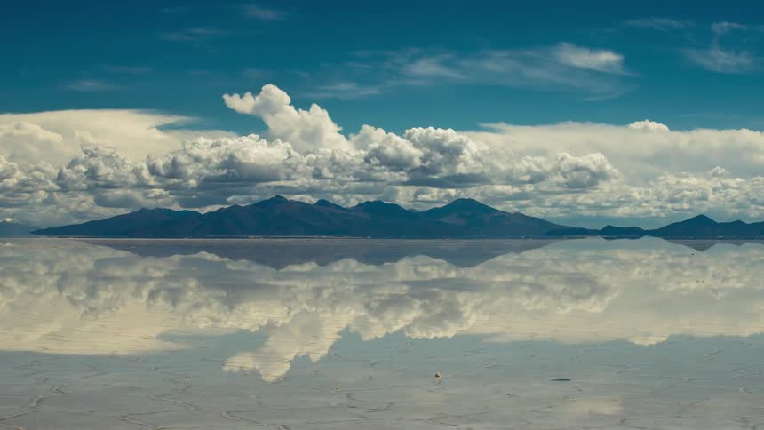 Clouds float over a mountain lake