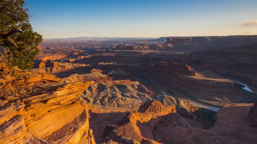 The sun begins to set over a large canyon