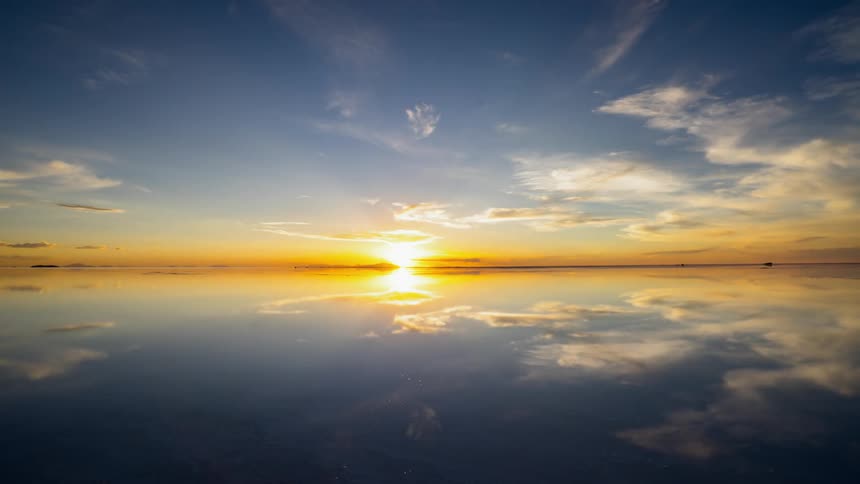 Clouds float over a lake at sunset