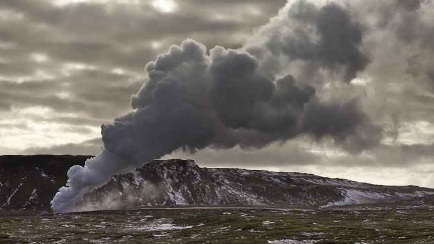 Steam erupting from the ground on a cloudy day
