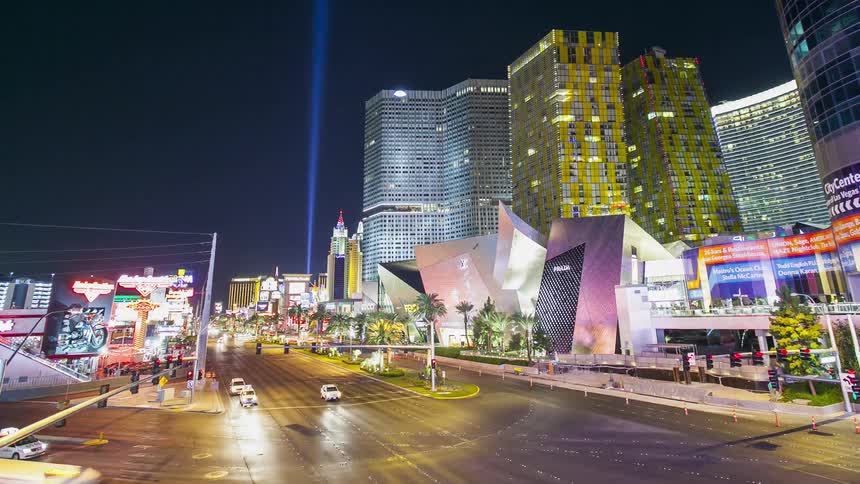 Vehicles travel on a city road at night