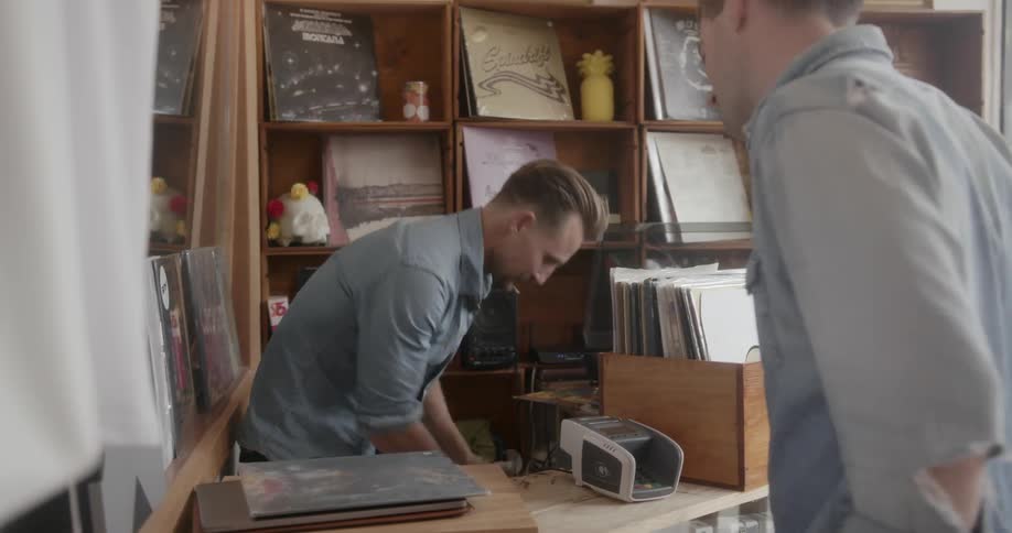 A man buys an album in a store