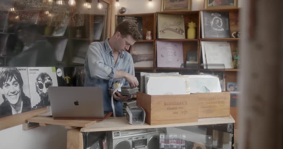 Man organizing records in a store